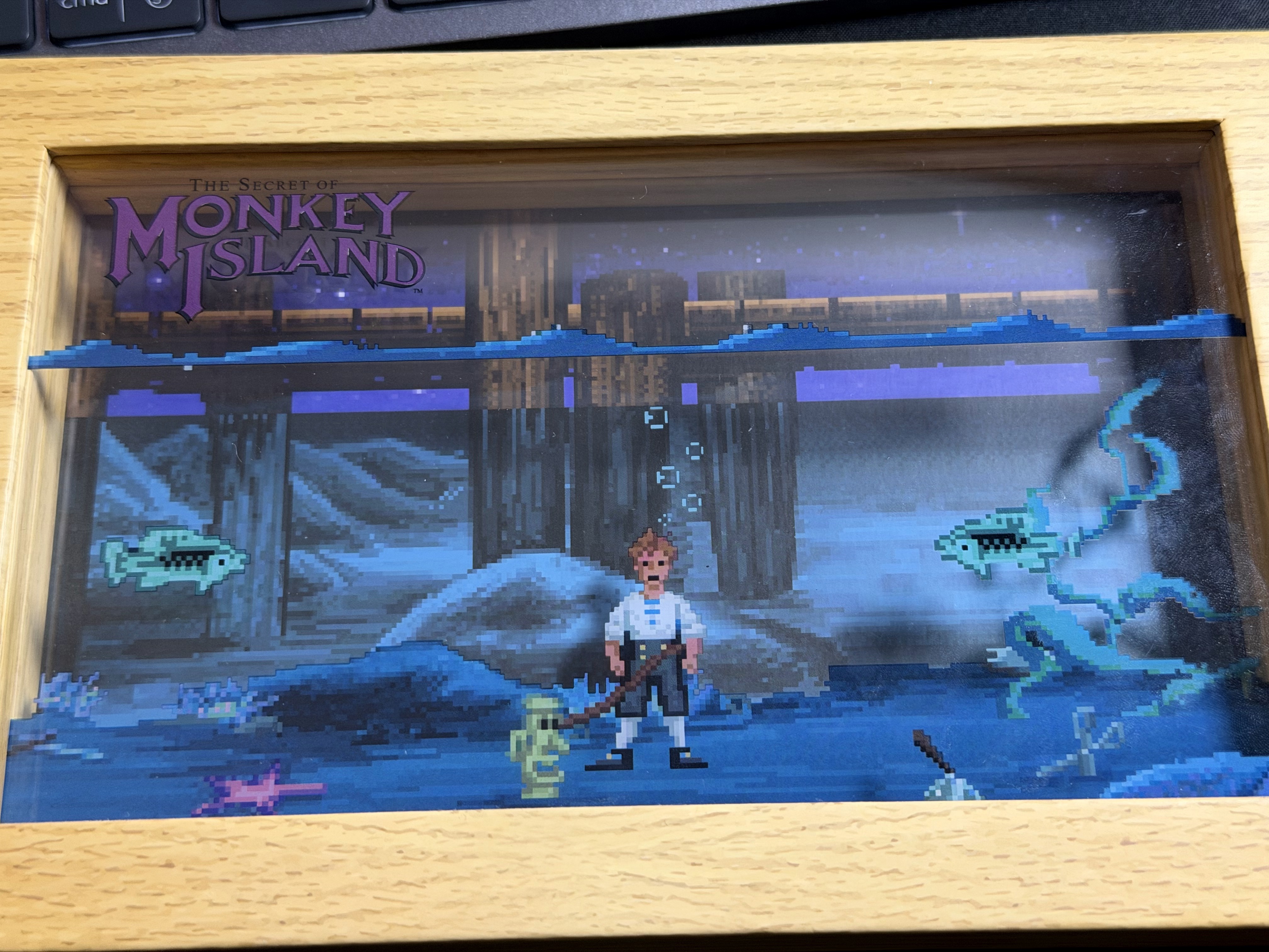 Una scena subacquea di The Secret of Monkey Island racchiusa in una cornice di legno.